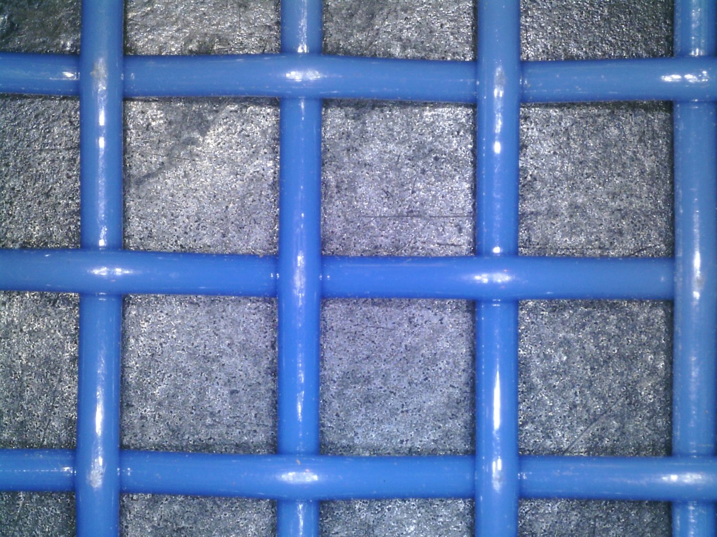 Electron-microscope close-up of blue polyester square mesh showing uniform square openings
